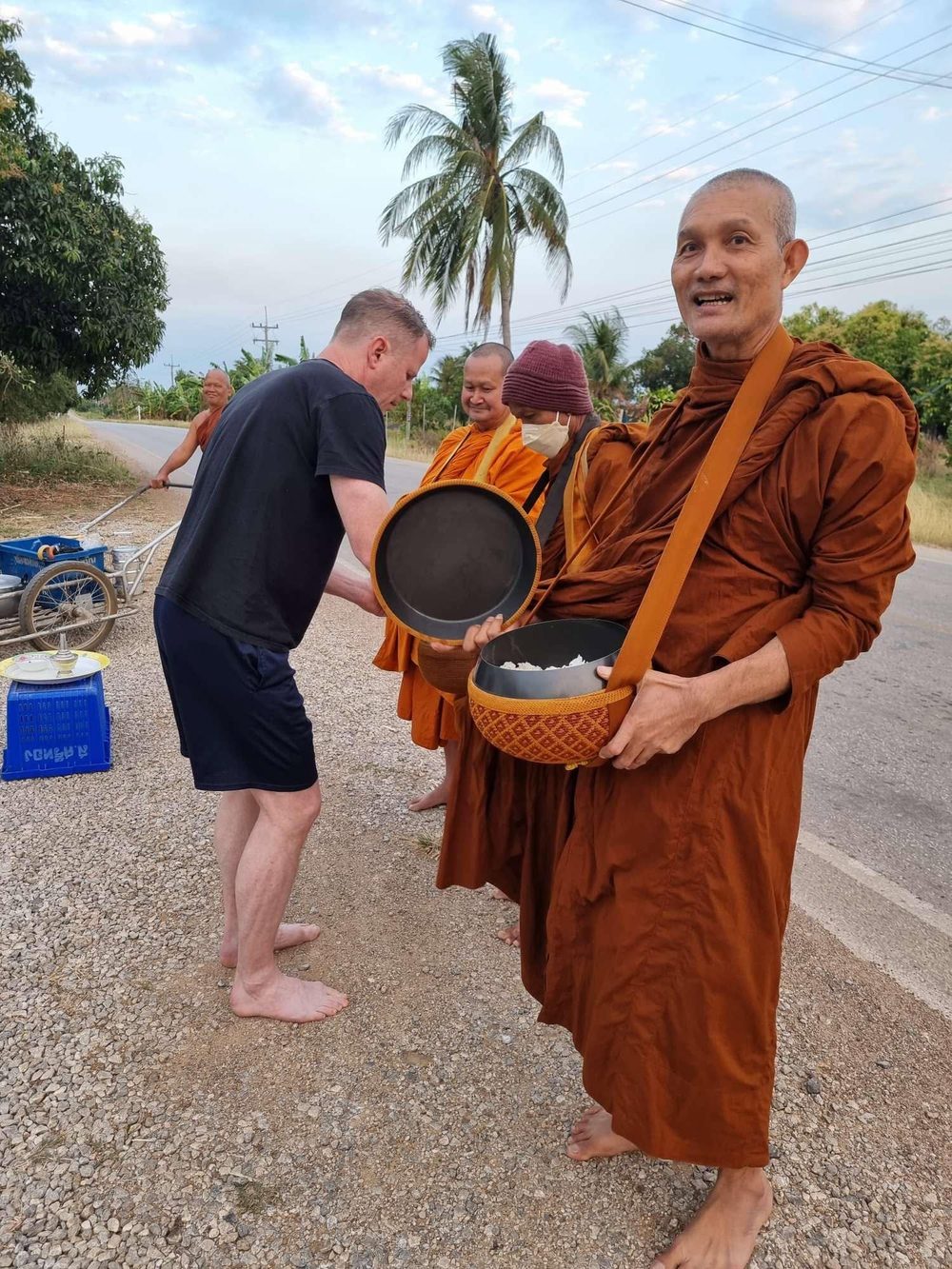 David DuVal giving alms to Buddhist monks in Thailand